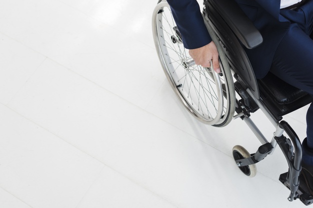 portrait-smiling-colleagues-standing-man-sitting-wheelchair_23-2148127425